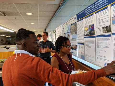 GSI tutorial participants discuss scientific posters.
